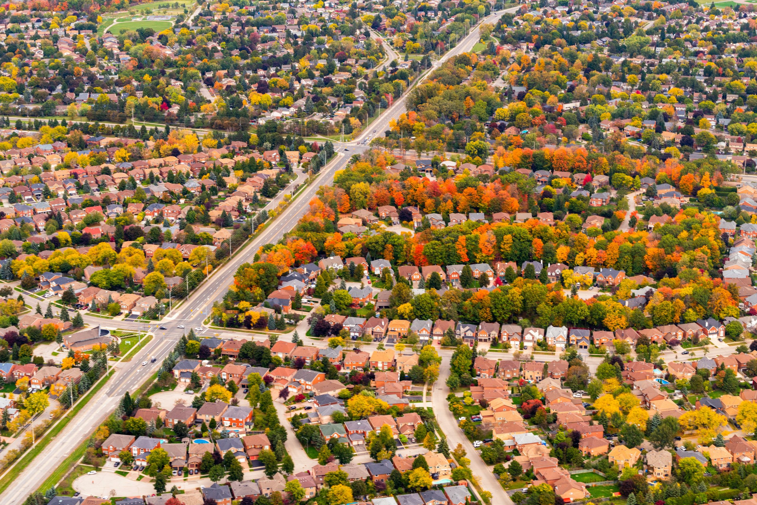 Aerial neighborhood view with autumn-colored trees